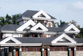 Close-up of two carpenters discussing the work on top of an unfinished roof